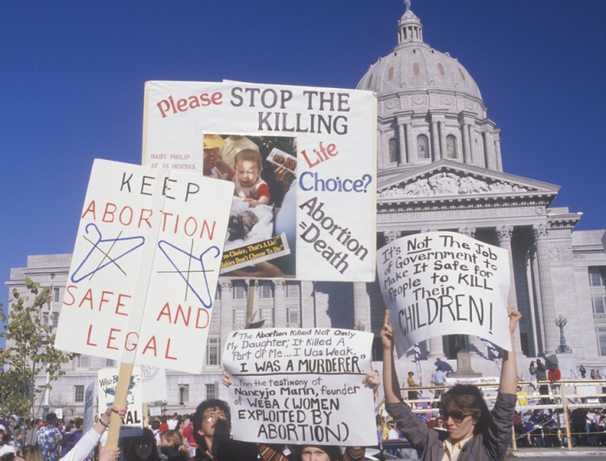 Women's rights marchers holding signs at State Capitol Building, Missouri, May 21, 2019. Women's rights marchers holding signs at State Capitol Building, Missouri, May 21, 2019.
