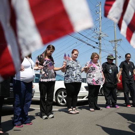 College students and others gather in prayer across the street where a gunman attacked a recruiting office in Chattanooga, Tenn. on July 17, 2015. College students and others gather in prayer across the street where a gunman attacked a recruiting office in Chattanooga, Tenn. on July 17, 2015.