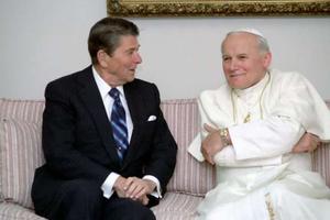 U.S. President Ronald Reagan talks with Pope St. John Paul II. U.S. President Ronald Reagan talks with Pope St. John Paul II.