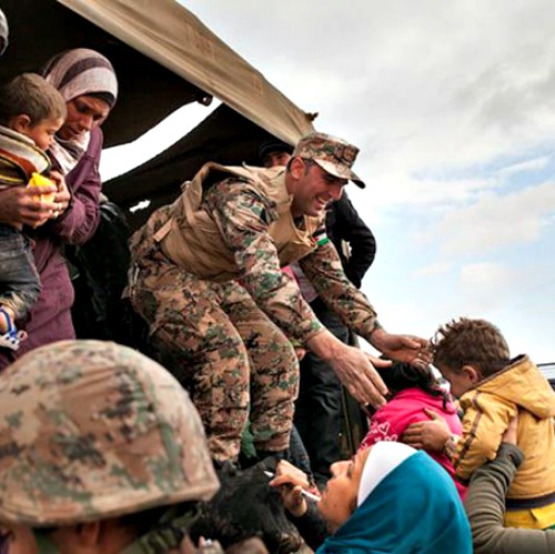 Jordanian troops and UNHCR officials help bring Syrian refugees to Jordan’s Zaatari refugee camp. Jordanian troops and UNHCR officials help bring Syrian refugees to Jordan’s Zaatari refugee camp.