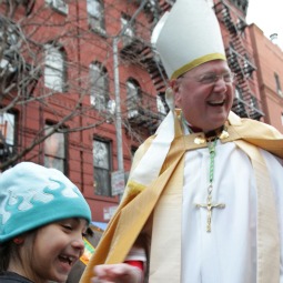 NEW JOB. Archbishop Timothy Dolan of New York reacts after having his photo taken by Ann Hamilton, 7, before presiding at inauguration ceremonies for the Basilica of St. Patrick's Old Cathedral in New York Dec. 5. NEW JOB. Archbishop Timothy Dolan of New York reacts after having his photo taken by Ann Hamilton, 7, before presiding at inauguration ceremonies for the Basilica of St. Patrick's Old Cathedral in New York Dec. 5.