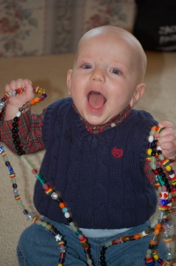 James holds a 14-foot-long strand of colorful beads, each with a color-coded meaning, that record the days he spent in the hospital. A beautiful, glass, heart-shaped bead marks the day James received his new heart. James holds a 14-foot-long strand of colorful beads, each with a color-coded meaning, that record the days he spent in the hospital. A beautiful, glass, heart-shaped bead marks the day James received his new heart.