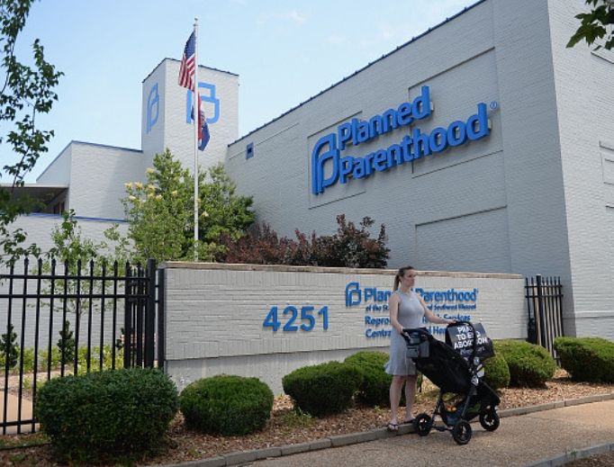 A woman stands with her child in a stroller during a pro-life rally outside the Planned Parenthood Reproductive Health Center on June 4 in St. Louis. The fate of Missouri's lone abortion facility will soon be decided. A woman stands with her child in a stroller during a pro-life rally outside the Planned Parenthood Reproductive Health Center on June 4 in St. Louis. The fate of Missouri's lone abortion facility will soon be decided.