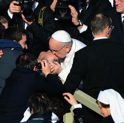 Pope Francis, greeting pilgrims gathered March 19 for his first Mass in St. Peter’s Square, kisses a disabled man on the forehead. Pope Francis, greeting pilgrims gathered March 19 for his first Mass in St. Peter’s Square, kisses a disabled man on the forehead.