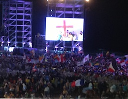Pilgrims carry WYD cross to the altar during the opening Mass of World Youth Day July 23. Pilgrims carry WYD cross to the altar during the opening Mass of World Youth Day July 23.