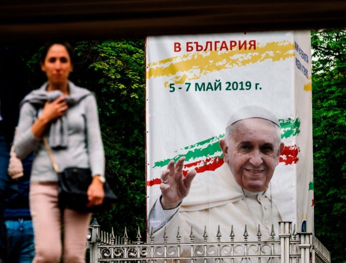 A woman walks past a billboard in downtown Sofia advertising Pope Francis' upcoming visit to Bulgaria, May 4. Pope Francis will arrive Sunday for a three-day visit to Bulgaria and North Macedonia. A woman walks past a billboard in downtown Sofia advertising Pope Francis' upcoming visit to Bulgaria, May 4. Pope Francis will arrive Sunday for a three-day visit to Bulgaria and North Macedonia.