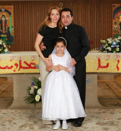 Father Wissam Akiki with his wife, Manal, and their daughter, Perla, at her first Communion.
Father Wissam Akiki with his wife, Manal, and their daughter, Perla, at her first Communion.
