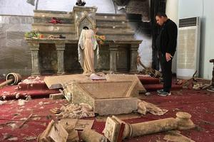 Priest examines ruins, including a decapitated statue of the Blessed Mother, in a Catholic church in Karamdes, Iraq, following the towns liberation from ISIS. Priest examines ruins, including a decapitated statue of the Blessed Mother, in a Catholic church in Karamdes, Iraq, following the towns liberation from ISIS.