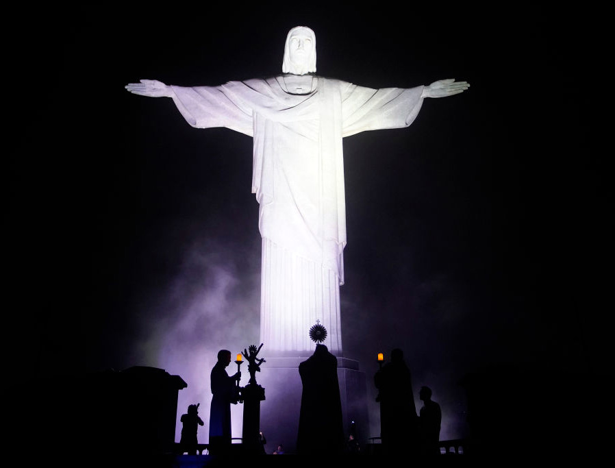 ABOVE: Archbishop Orani João Tempesta carries the Blessed Sacrament at an illuminated Christ the Redeemer statue March 18 in Rio de Janeiro, Brazil. (Photo by Wagner Meier/Getty Images). BELOW (INSET 1): Photo by Patti Armstrong. BELOW (INSET 2): Courtesy of Father Brian Kasso. ABOVE: Archbishop Orani João Tempesta carries the Blessed Sacrament at an illuminated Christ the Redeemer statue March 18 in Rio de Janeiro, Brazil. (Photo by Wagner Meier/Getty Images). BELOW (INSET 1): Photo by Patti Armstrong. BELOW (INSET 2): Courtesy of Father Brian Kasso.
