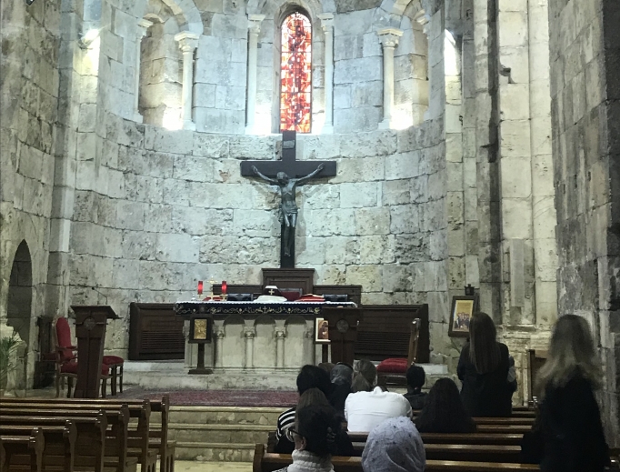 Above, worshippers pray in St. John-Marc Cathedral in Byblos; below, a portrait of St. Charbel graces the entrance of the Monastery of St. Maron. Above, worshippers pray in St. John-Marc Cathedral in Byblos; below, a portrait of St. Charbel graces the entrance of the Monastery of St. Maron.