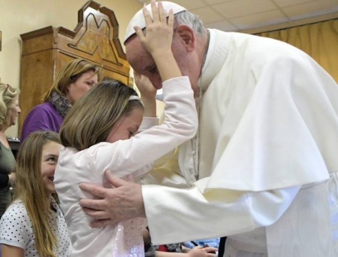 Holy Father shares a blessed moment with a young resident of St. Alessio-Margherita di Savoia Regional Center. Holy Father shares a blessed moment with a young resident of St. Alessio-Margherita di Savoia Regional Center.