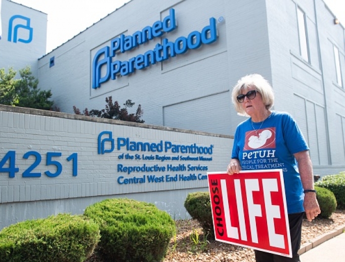 Above, a pro-life demonstrator walks outside the Planned Parenthood Reproductive Health Services Center in St. Louis May 31. A coalition of pro-abortion groups has released a document outlining vision of abortion with no restrictions, no religious exemptions, and funded by the government. Above, a pro-life demonstrator walks outside the Planned Parenthood Reproductive Health Services Center in St. Louis May 31. A coalition of pro-abortion groups has released a document outlining vision of abortion with no restrictions, no religious exemptions, and funded by the government.