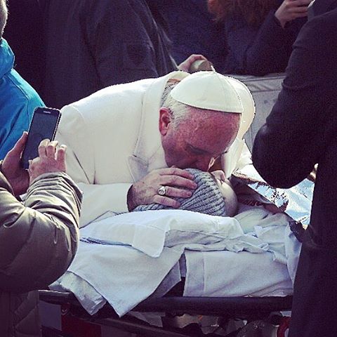 Pope Francis kisses a child who is bedridden on Feb. 10, Ash Wednesday, in St. Peter's Square. Pope Francis kisses a child who is bedridden on Feb. 10, Ash Wednesday, in St. Peter's Square.