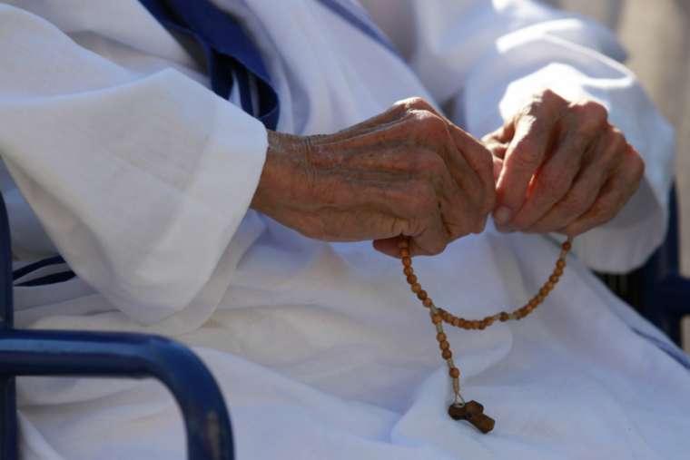 Missionary of Charity sister prays the Rosary.
Missionary of Charity sister prays the Rosary.