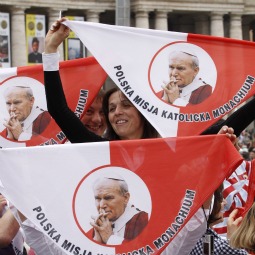 Pilgrims hold handkerchiefs featuring Blessed Pope John Paul II before the start of a Mass of thanksgiving in celebration of his beatification in St. Peter’s Square at the Vatican May 2. The Mass was celebrated by Cardinal Tarcisio Bertone, the Vatican’s secretary of state. Pilgrims hold handkerchiefs featuring Blessed Pope John Paul II before the start of a Mass of thanksgiving in celebration of his beatification in St. Peter’s Square at the Vatican May 2. The Mass was celebrated by Cardinal Tarcisio Bertone, the Vatican’s secretary of state.