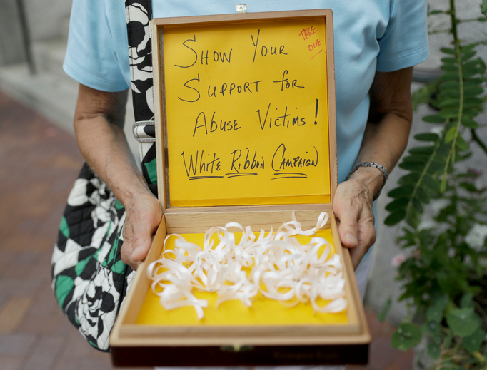 Irene Youngman holds a box of ribbons to be given away before a Mass lead by Bishop Ronald Gainer of the Harrisburg Diocese at the Cathedral Church of St. Patrick in Harrisburg, Pennsylvania, Aug. 17. The grand jury report found rampant sexual abuse of more than 1,000 children by about 300 priests in six Pennsylvania dioceses over seven decades. It criticized Bishop Gainer for advocating to the Vatican that two abusive priests not be defrocked. Irene Youngman holds a box of ribbons to be given away before a Mass lead by Bishop Ronald Gainer of the Harrisburg Diocese at the Cathedral Church of St. Patrick in Harrisburg, Pennsylvania, Aug. 17. The grand jury report found rampant sexual abuse of more than 1,000 children by about 300 priests in six Pennsylvania dioceses over seven decades. It criticized Bishop Gainer for advocating to the Vatican that two abusive priests not be defrocked.