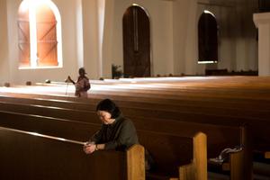 Above, Carolyn Woo, president of CRS, prays inside the transitional cathedral, which temporarily accommodates Dame de l'Assomption (Our Lady of the Assumption). Below, Woo holds a Jordanian girl, Lubna, 6, who has autism, during a drawing class in the center's Autism Room, which is supported by Caritas. Woo washes her hands with Qaru Lambo primary-school students in Karatu, Tanzania. Above, Carolyn Woo, president of CRS, prays inside the transitional cathedral, which temporarily accommodates Dame de l'Assomption (Our Lady of the Assumption). Below, Woo holds a Jordanian girl, Lubna, 6, who has autism, during a drawing class in the center's Autism Room, which is supported by Caritas. Woo washes her hands with Qaru Lambo primary-school students in Karatu, Tanzania.