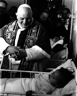 John XXIII visits children in a hospital. John XXIII visits children in a hospital.