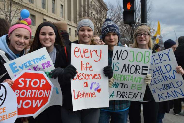 Young people hold signs opposing abortion during a past March for Life in Washington. Young people hold signs opposing abortion during a past March for Life in Washington.