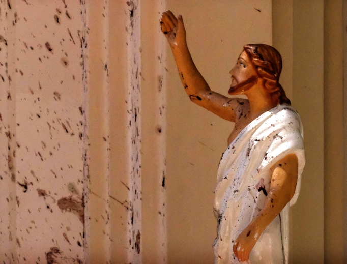 Blood stains are seen on the wall and on a Jesus Christ statue at St. Sebastian's Church April 21 after a blast in Negombo, north of Colombo, Sri Lanka. Sri Lankan authorities blame a militant group for coordinated Easter bombings that ripped through Sri Lankan churches and luxury hotels, killing and injuring hundreds of people. It was Sri Lanka's deadliest violence since a devastating civil war in the South Asian island nation ended a decade ago. Blood stains are seen on the wall and on a Jesus Christ statue at St. Sebastian's Church April 21 after a blast in Negombo, north of Colombo, Sri Lanka. Sri Lankan authorities blame a militant group for coordinated Easter bombings that ripped through Sri Lankan churches and luxury hotels, killing and injuring hundreds of people. It was Sri Lanka's deadliest violence since a devastating civil war in the South Asian island nation ended a decade ago.