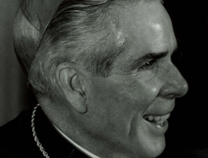 Above, Archbishop Sheen's portrait as it appears on a holy card; below, James Fulton Engstrom is held by his parents, Travis and Bonnie Engstrom, as the tribunal to investigate his miraculous healing through the intercession of Venerable Archbishop Fulton Sheen began on Sept. 7, 2011. With them at the Spalding Pastoral Center in Peoria is Bishop Daniel Jenky of the Diocese of Peoria. Above, Archbishop Sheen's portrait as it appears on a holy card; below, James Fulton Engstrom is held by his parents, Travis and Bonnie Engstrom, as the tribunal to investigate his miraculous healing through the intercession of Venerable Archbishop Fulton Sheen began on Sept. 7, 2011. With them at the Spalding Pastoral Center in Peoria is Bishop Daniel Jenky of the Diocese of Peoria.