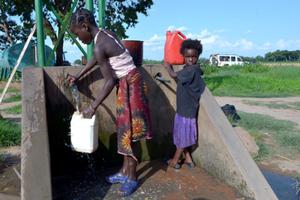 African children fetch water many miles away from home and do not attend school to help their family in Lusaka, Zambia. African children fetch water many miles away from home and do not attend school to help their family in Lusaka, Zambia.