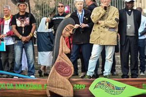 A wooden carved sculpture is pictured during a procession of indigenous leaders, prelates and people participating in the Special Assembly of the Synod of Bishops for the Pan-Amazon Region, on Oct. 19 between Rome's Castel Sant'Angelo and the Vatican's St. Peters Square. A wooden carved sculpture is pictured during a procession of indigenous leaders, prelates and people participating in the Special Assembly of the Synod of Bishops for the Pan-Amazon Region, on Oct. 19 between Rome's Castel Sant'Angelo and the Vatican's St. Peters Square.