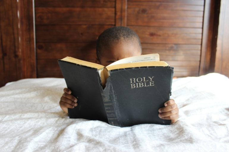 Child reading the Holy Bible Child reading the Holy Bible