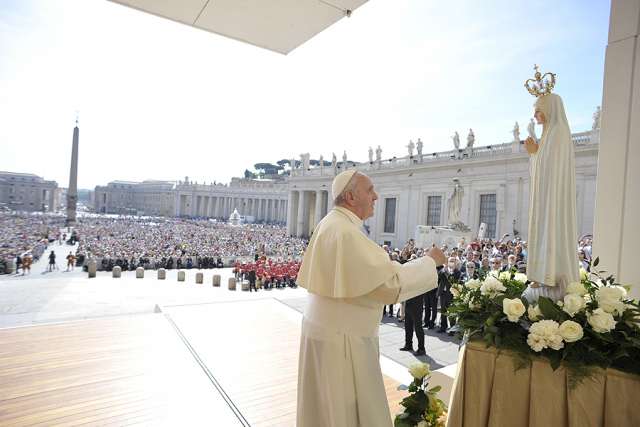 Pope Francis prays in front of a statue of Our Lady of Fatima on the feast day of Our Lady of Fatima, May 13, 2015, in St. Peter's Square.
Pope Francis prays in front of a statue of Our Lady of Fatima on the feast day of Our Lady of Fatima, May 13, 2015, in St. Peter's Square.