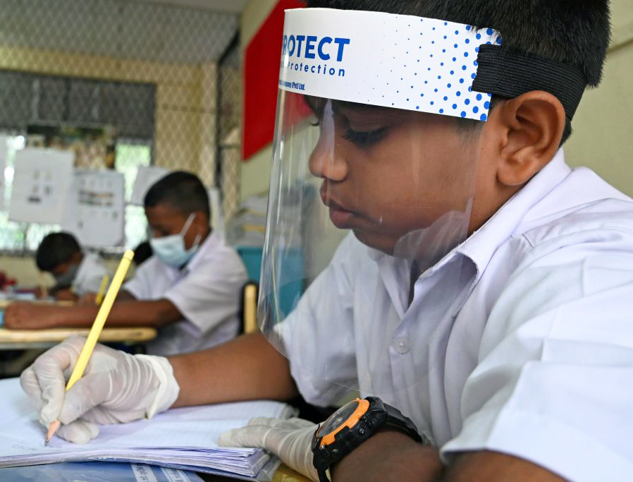 A student wearing a face shield sits in a classroom after their school was reopened in Colombo, Sri Lanka, July 6. A student wearing a face shield sits in a classroom after their school was reopened in Colombo, Sri Lanka, July 6.