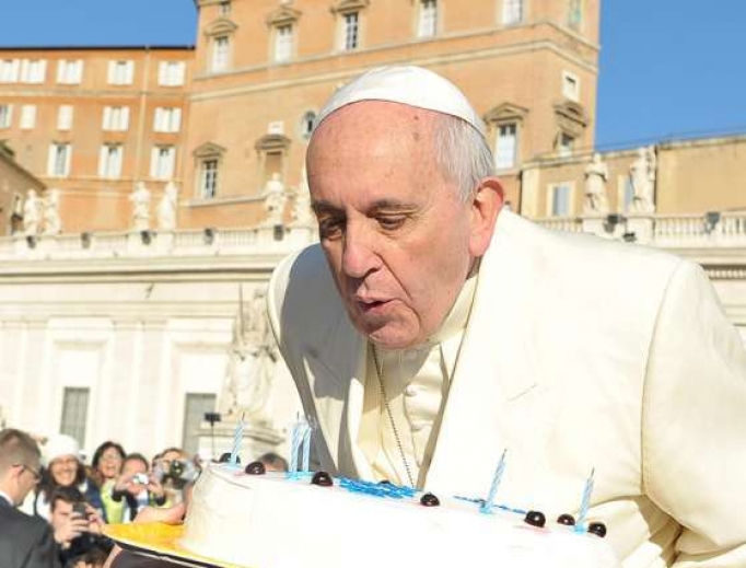 Pope Francis blows out candles on a birthday cake at his Dec. 17, 2014, audience. Pope Francis blows out candles on a birthday cake at his Dec. 17, 2014, audience.