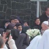 Pope Francis receives white roses from nuns during surprise visit Feb. 14. Pope Francis receives white roses from nuns during surprise visit Feb. 14.