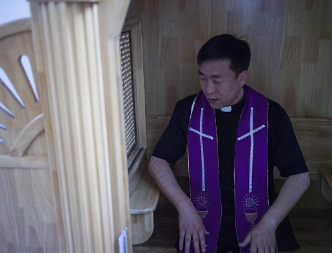 Chinese priest Lin Xiuqiang poses for a photograph in his Catholic church in Tianjin. Dozens of church buildings have been demolished and crosses removed in recent months. Chinese priest Lin Xiuqiang poses for a photograph in his Catholic church in Tianjin. Dozens of church buildings have been demolished and crosses removed in recent months.