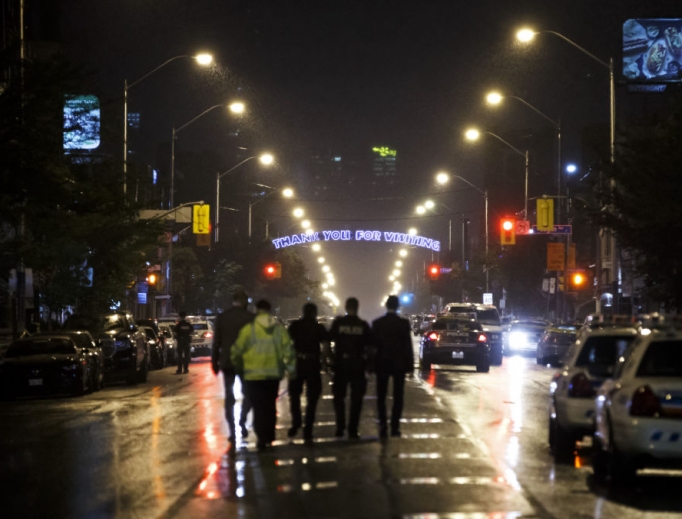 Toronto police officers work at the scene of a shooting in Toronto July 23. A gunman opened fire in central Toronto on Sunday night, injuring 13 people and killing two, including a child, police reported. Toronto police officers work at the scene of a shooting in Toronto July 23. A gunman opened fire in central Toronto on Sunday night, injuring 13 people and killing two, including a child, police reported.