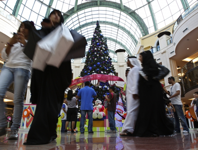 An Emirati couple and people of other nationalities pass by a giant Christmas tree at a shopping mall in Dubai, United Arab Emirates. Pope Francis will make the first papal visit to the Arabian Peninsula next month. An Emirati couple and people of other nationalities pass by a giant Christmas tree at a shopping mall in Dubai, United Arab Emirates. Pope Francis will make the first papal visit to the Arabian Peninsula next month.