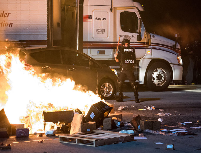 A police officer stands guard near a fire on the I-85 during protests in the early hours of Sept. 21 in Charlotte, North Carolina. The protests followed the fatal shooting of 43-year-old Keith Lamont Scott by a police officer at an apartment complex near UNC Charlotte.
A police officer stands guard near a fire on the I-85 during protests in the early hours of Sept. 21 in Charlotte, North Carolina. The protests followed the fatal shooting of 43-year-old Keith Lamont Scott by a police officer at an apartment complex near UNC Charlotte.