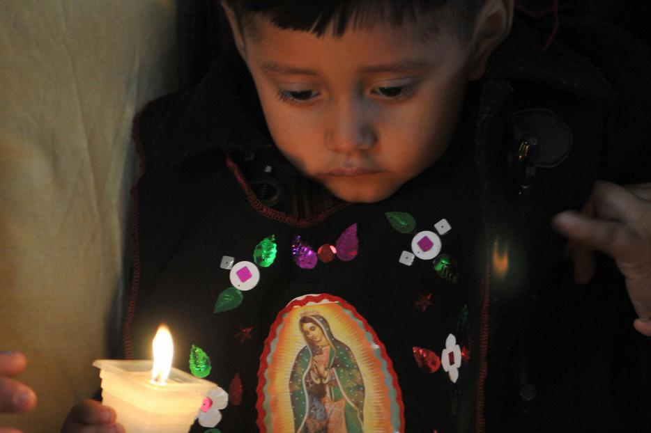 A boy lights a candle in the sanctuary of Our Lady of Guadalupe in Guatemala City, Dec. 12, 2008. A boy lights a candle in the sanctuary of Our Lady of Guadalupe in Guatemala City, Dec. 12, 2008.