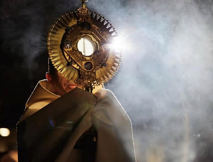 Father Michael Delcambre of Broussard, Louisiana, carries the Blessed Sacrament in procession. Father Michael Delcambre of Broussard, Louisiana, carries the Blessed Sacrament in procession.