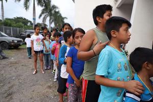 Children line up outside a shelter in Guatemala after a 2018 volcano eruption. Children line up outside a shelter in Guatemala after a 2018 volcano eruption.