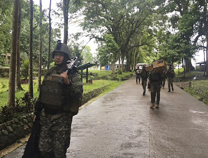 Philippine troops arrive at their barracks to reinforce fellow troops following the siege by Muslim militants May 24 on the outskirts of Marawi city in the southern Philippines. The militants burned buildings and took hostages. Philippine troops arrive at their barracks to reinforce fellow troops following the siege by Muslim militants May 24 on the outskirts of Marawi city in the southern Philippines. The militants burned buildings and took hostages.