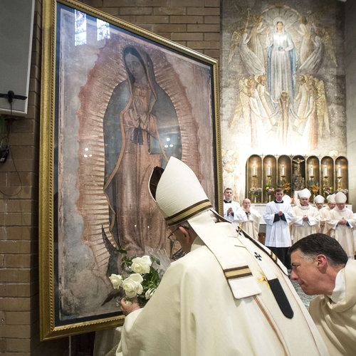 Pope Francis places a bouquet of roses in front of Our Lady of Guadalupe image at the conclusion of Mass celebrated at the Pontifical North American College in Rome on May 2, 2015.
Pope Francis places a bouquet of roses in front of Our Lady of Guadalupe image at the conclusion of Mass celebrated at the Pontifical North American College in Rome on May 2, 2015.