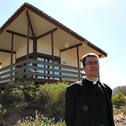 Father Eugene Florea stands in front of a newly built hermitage. Father Eugene Florea stands in front of a newly built hermitage.