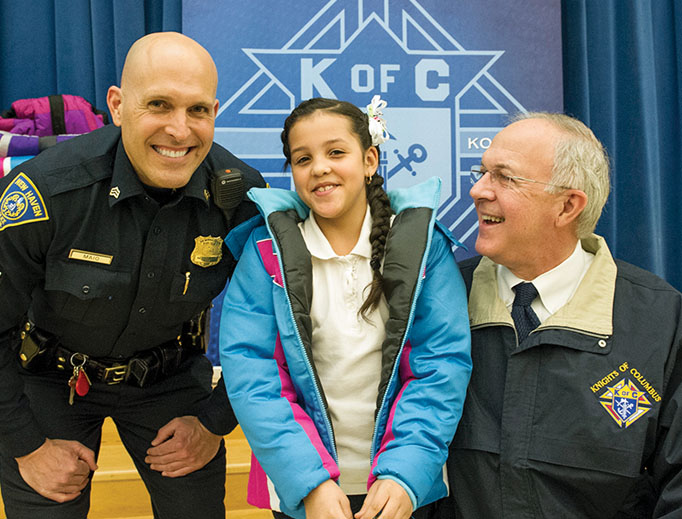 Supreme Knight Carl Anderson and New Haven police distribute coats during a 2016 ‘Coats for Kids’ event at a local school.
Supreme Knight Carl Anderson and New Haven police distribute coats during a 2016 ‘Coats for Kids’ event at a local school.
