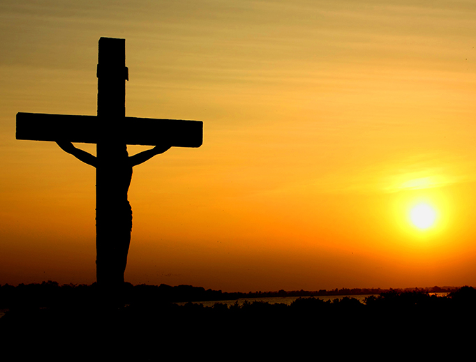 A crucifix silhouetted against the sunset in Batticaloa, Sri Lanka. A crucifix silhouetted against the sunset in Batticaloa, Sri Lanka.