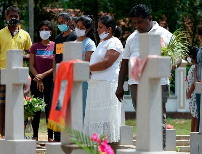 Relatives pay their respects at a graveyard for St. Sebastian's Church bomb blasts victims in Negombo on April 21, 2020, to mark the first anniversary of the attacks. Relatives pay their respects at a graveyard for St. Sebastian's Church bomb blasts victims in Negombo on April 21, 2020, to mark the first anniversary of the attacks.