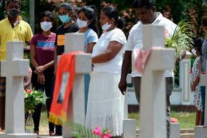 Relatives pay their respects at a graveyard for St. Sebastian's Church bomb blasts victims in Negombo on April 21, 2020, to mark the first anniversary of the attacks. Relatives pay their respects at a graveyard for St. Sebastian's Church bomb blasts victims in Negombo on April 21, 2020, to mark the first anniversary of the attacks.
