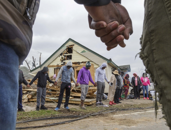 Residents of Talbotton, Georgia, pray together March 4 outside a home destroyed by a tornado; the moment of prayer came the day after storms battered Alabama and Georgia. Residents of Talbotton, Georgia, pray together March 4 outside a home destroyed by a tornado; the moment of prayer came the day after storms battered Alabama and Georgia.