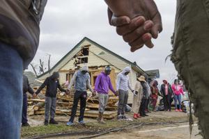 Residents of Talbotton, Georgia, pray together March 4 outside a home destroyed by a tornado; the moment of prayer came the day after storms battered Alabama and Georgia. Residents of Talbotton, Georgia, pray together March 4 outside a home destroyed by a tornado; the moment of prayer came the day after storms battered Alabama and Georgia.
