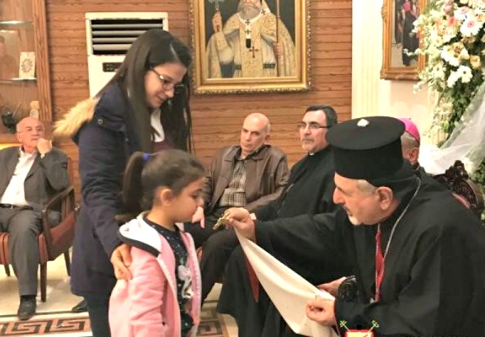 Patriarch Younan blesses a child in Aleppo, Syria. Patriarch Younan blesses a child in Aleppo, Syria.