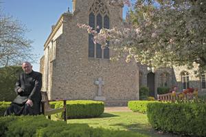 Msgr. John Armitage, shown enjoying the garden and praying at the Walsingham shrine, says, ‘Our Lady wanted us to make the dedication in the midst of this storm.’ Msgr. John Armitage, shown enjoying the garden and praying at the Walsingham shrine, says, ‘Our Lady wanted us to make the dedication in the midst of this storm.’